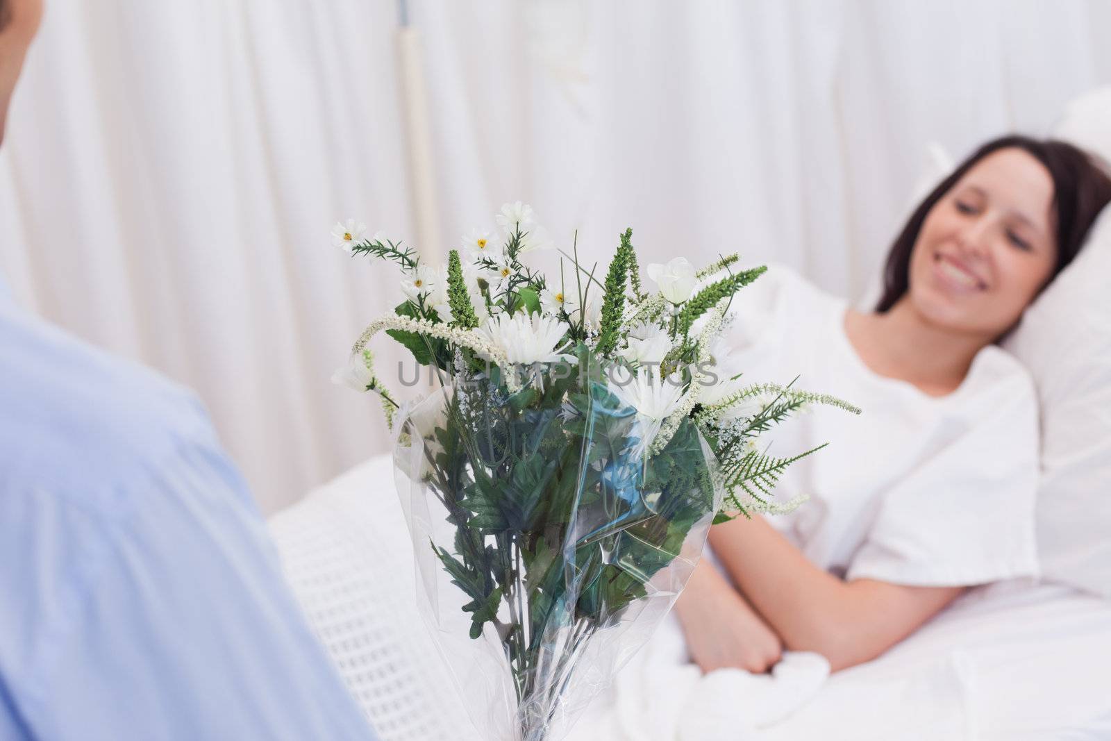 Flowers are brought to female patient