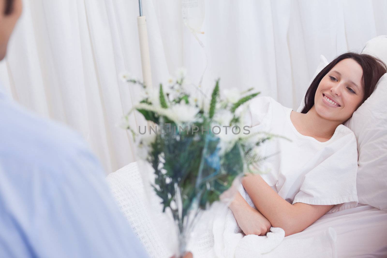 Young female patient getting flowers