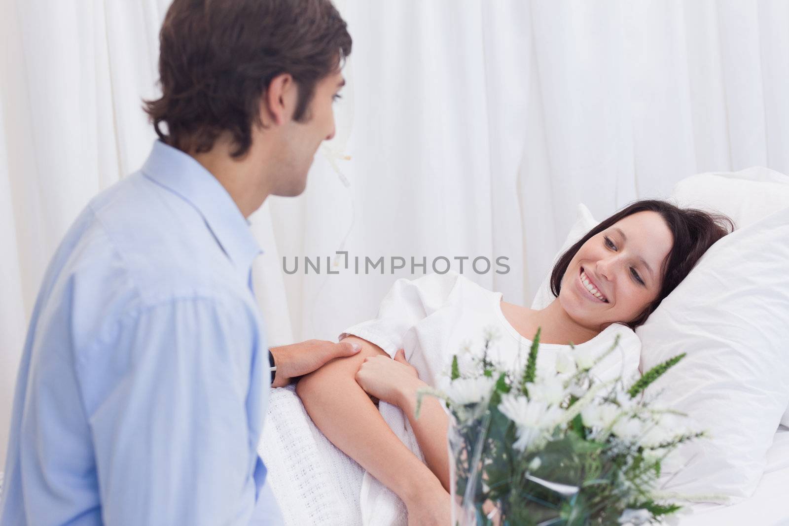 Young man visiting his girlfriend in the hospital
