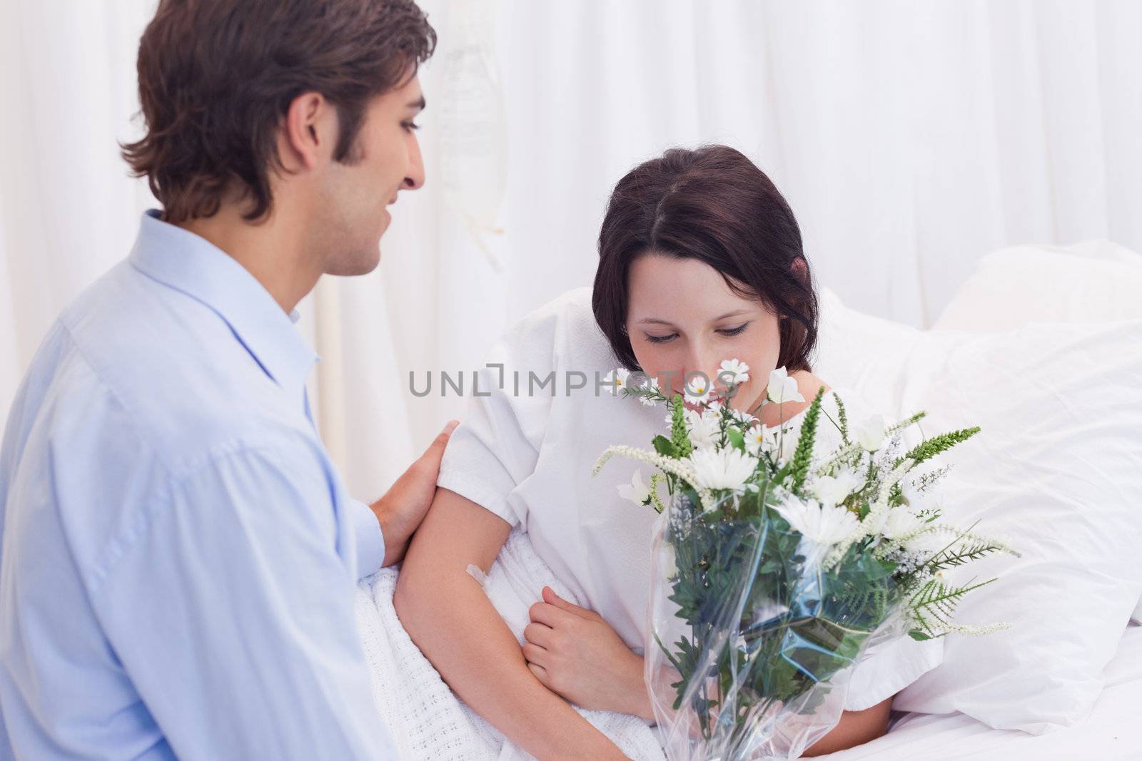 Young man brought flowers to his girlfriend in the hospital