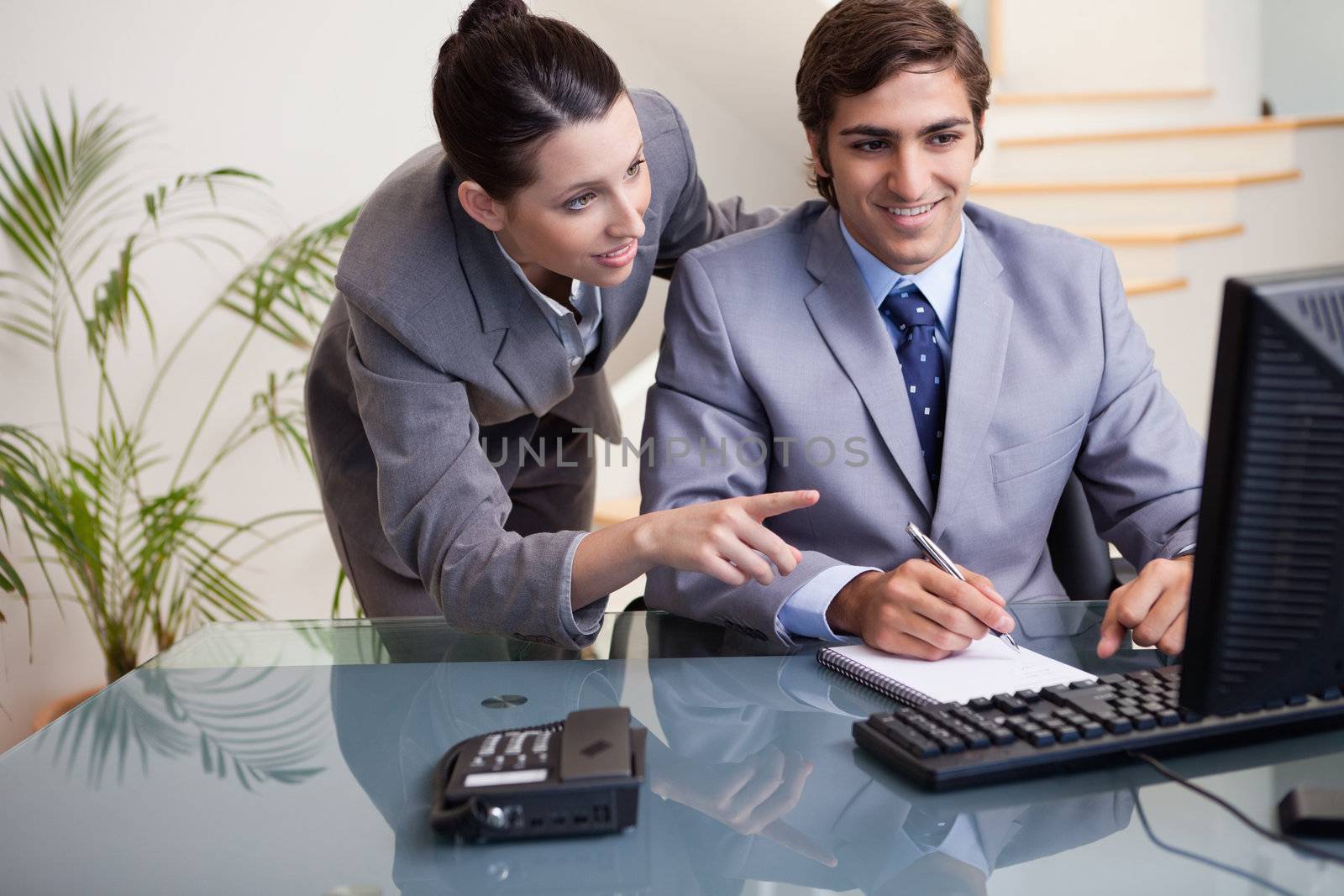 Young businessman explaining her colleague what he has to do