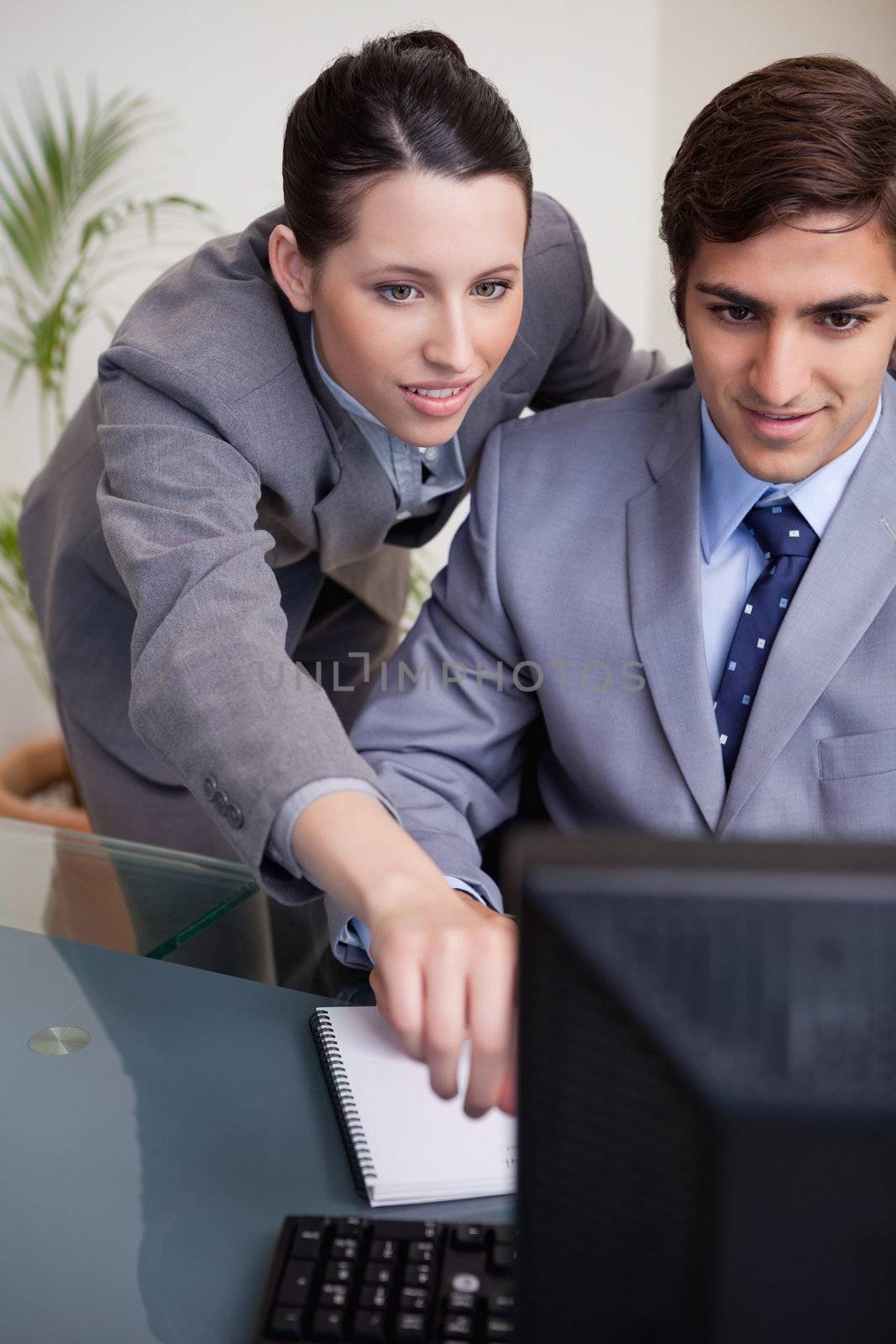 Businesswoman explaining her colleague what his task is by Wavebreakmedia
