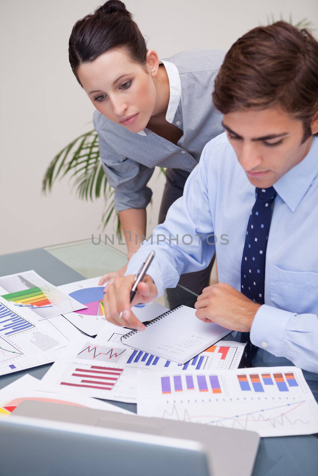 Young business team analyzing statistics together
