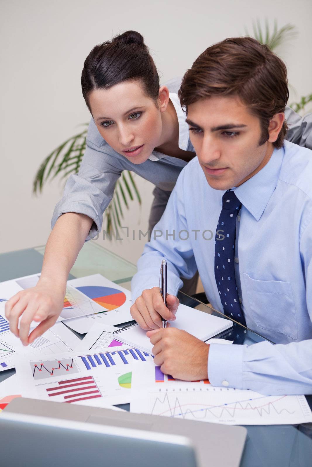 Young business team working on statistics together