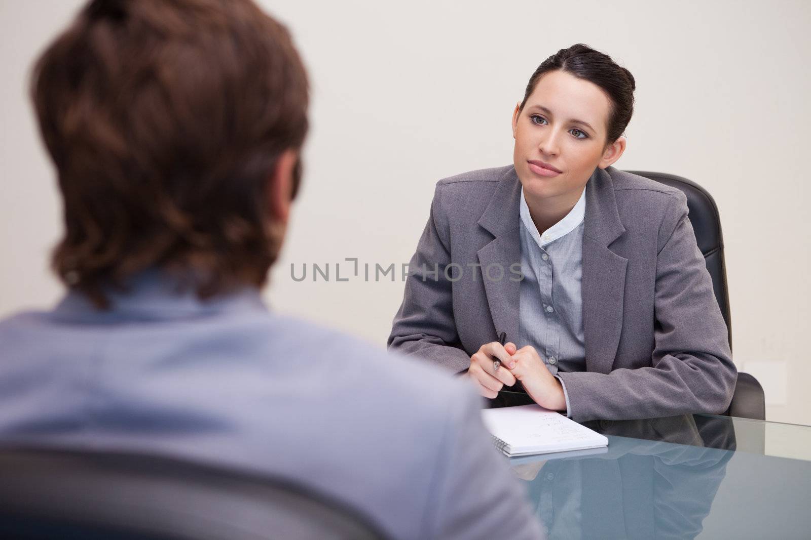 Young businesswoman listening to her business partner