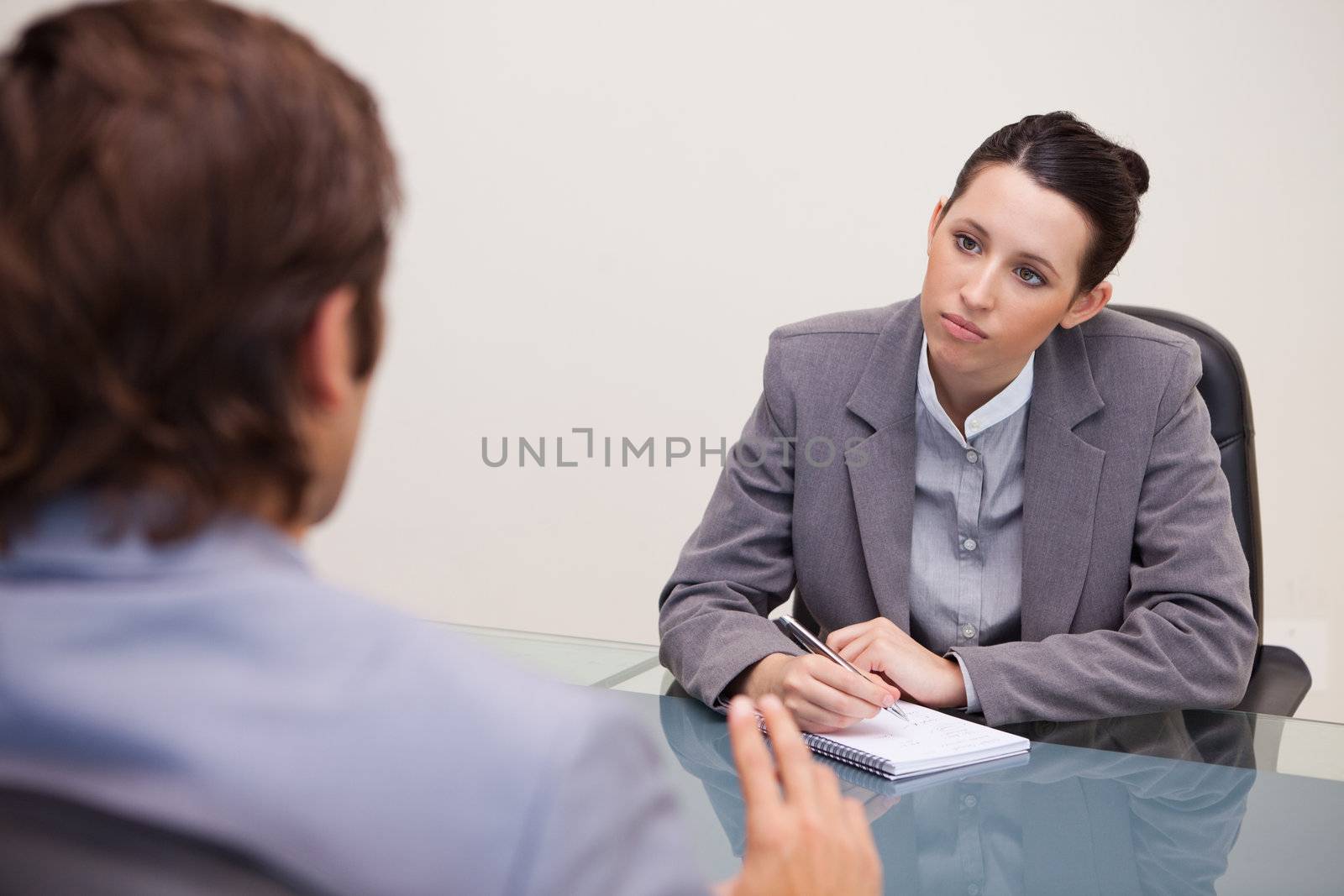 Young businesswoman taking notes in a meeting
