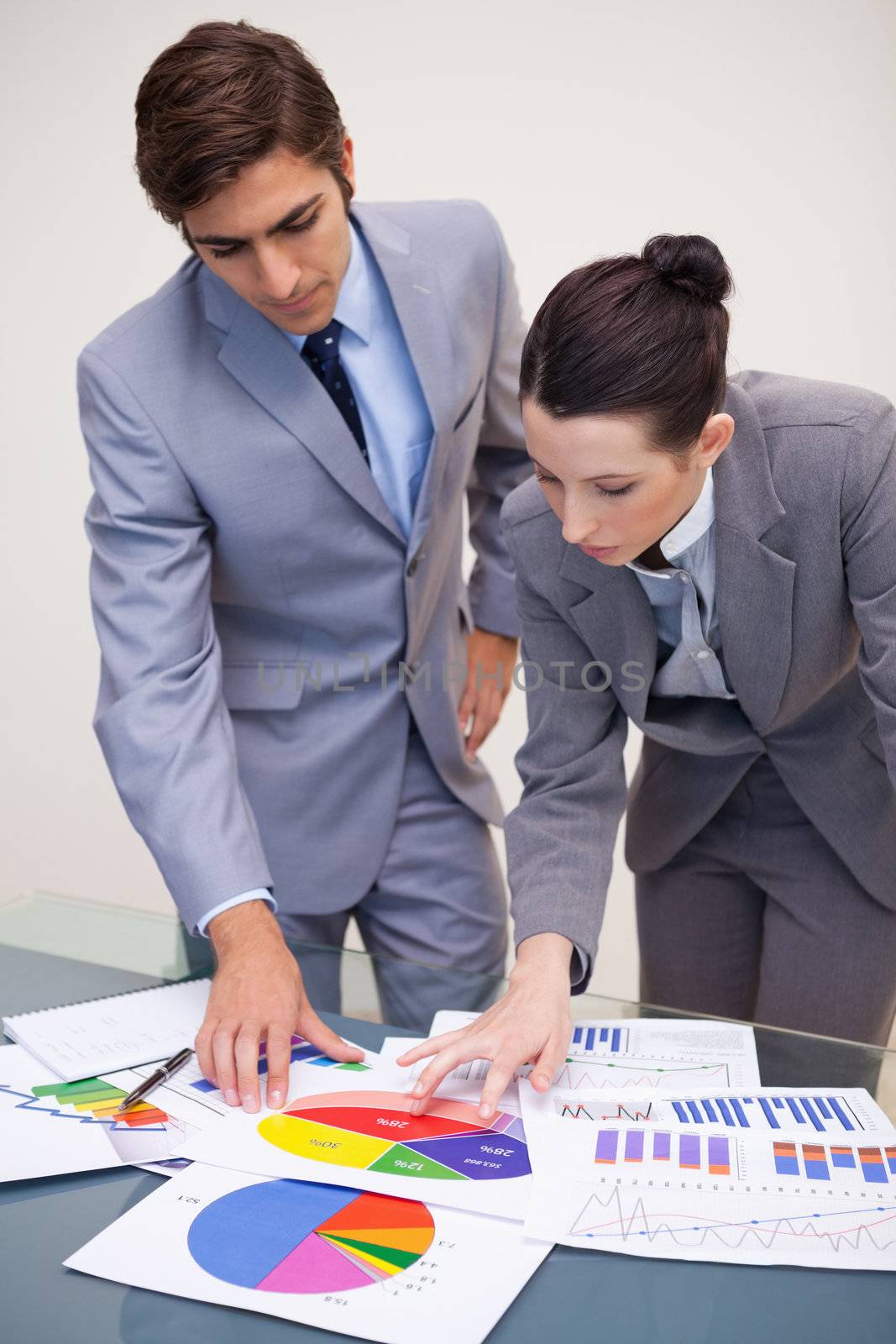 Young business partners looking at statistics together