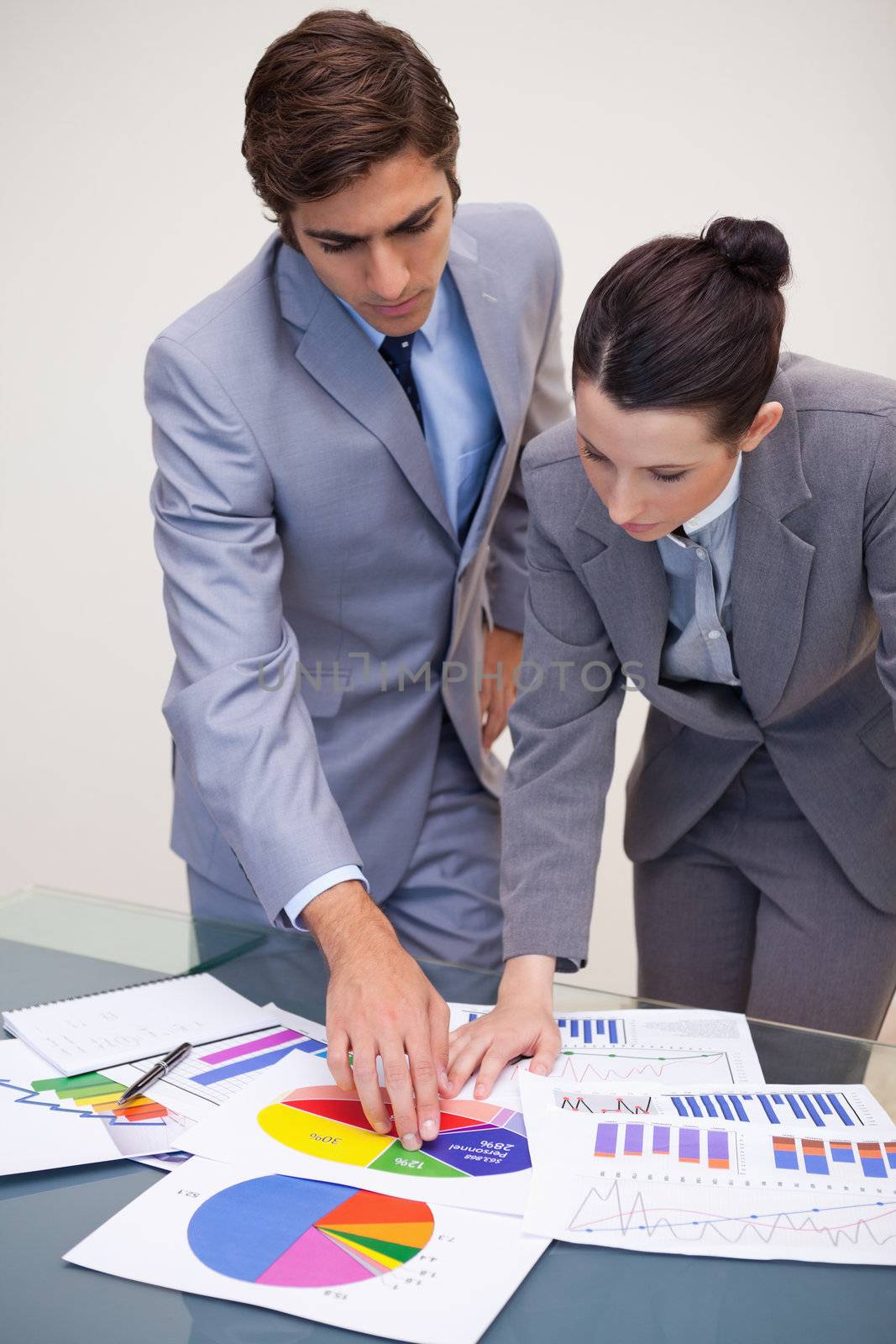 Young consultant and customer looking at statistics