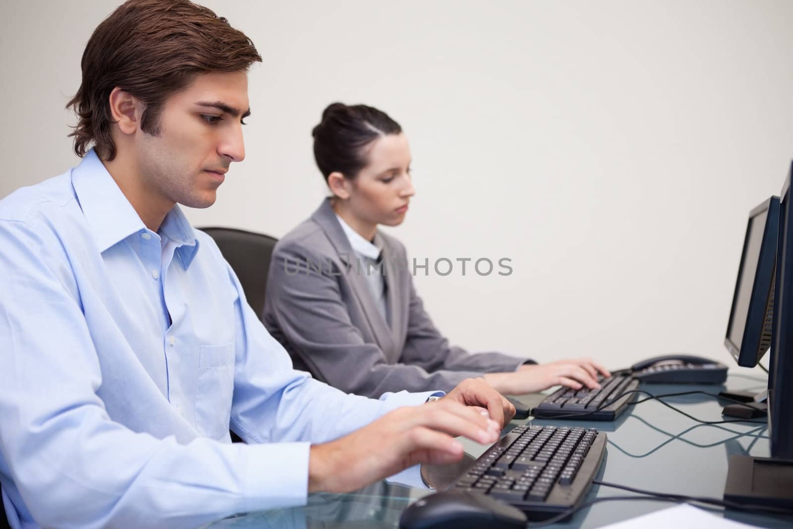 Side view of young business team working next to each other