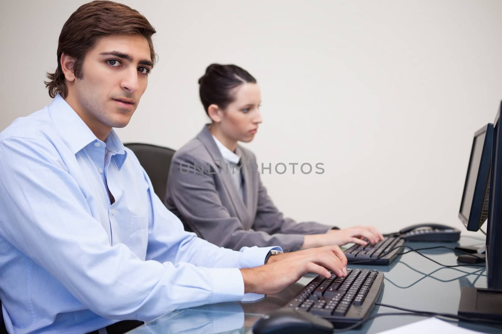 Side view of young business people working next to each other
