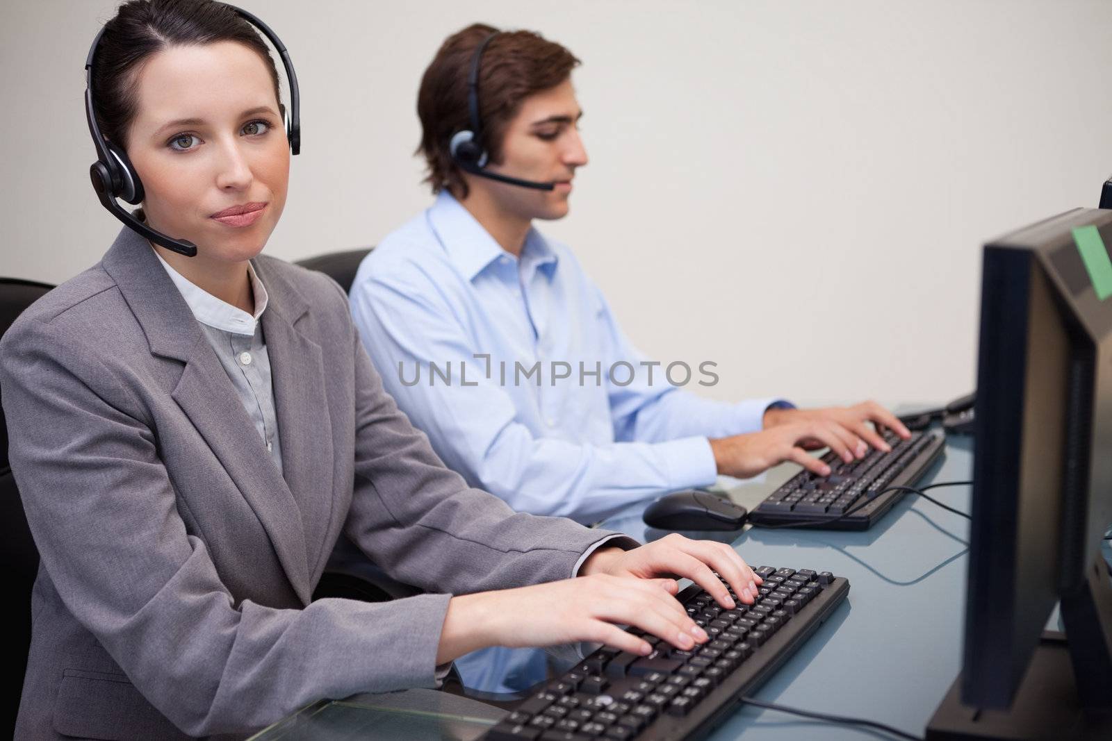 Side view of working young call center agents