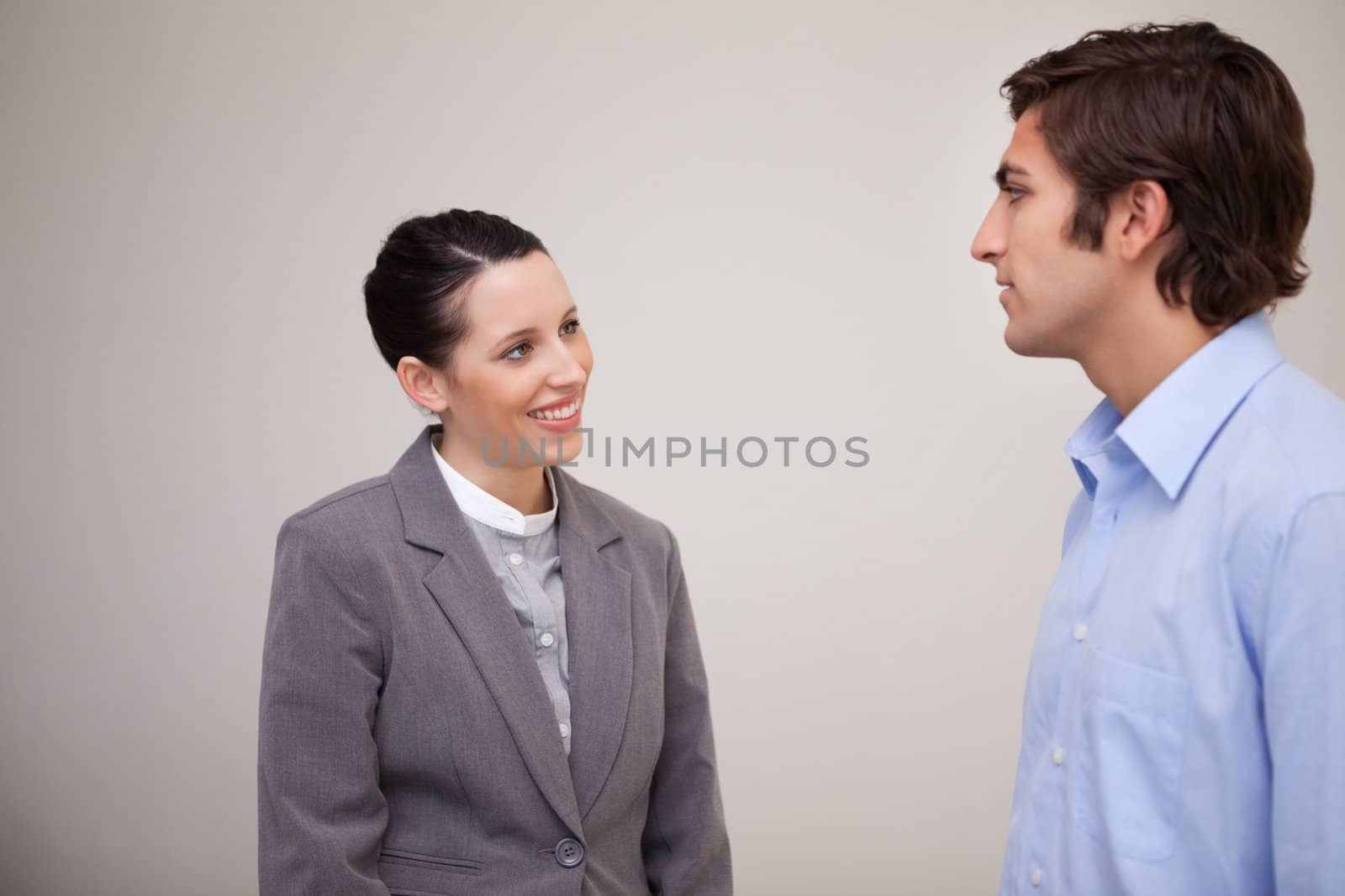 Young businesswoman smiling at her colleague