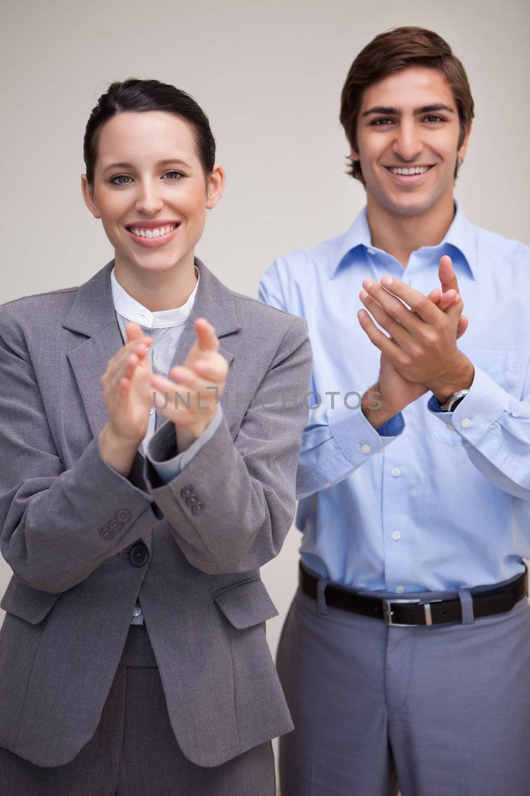 Standing young business team applauding