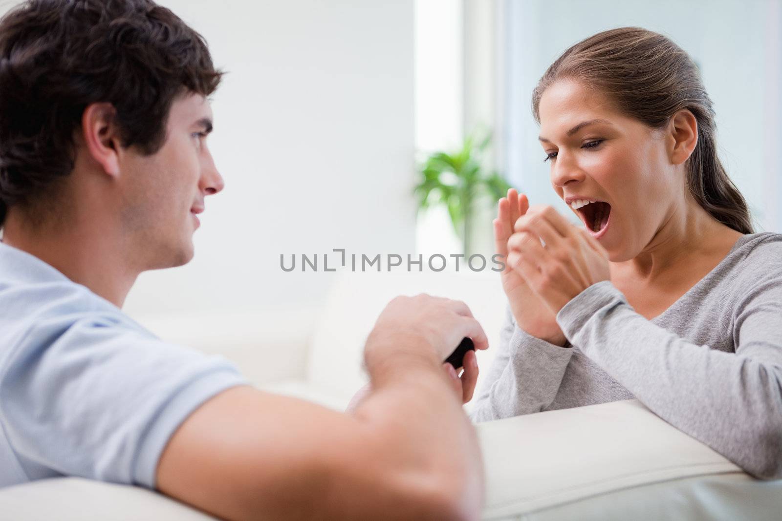 Young man surprising his girlfriend with a proposal