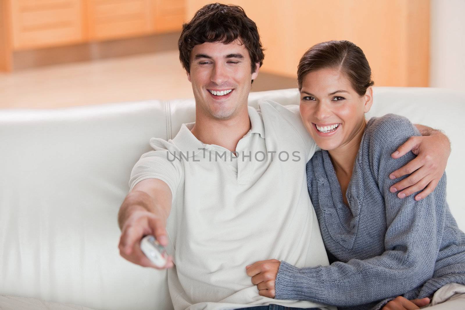 Young couple watching television on the couch