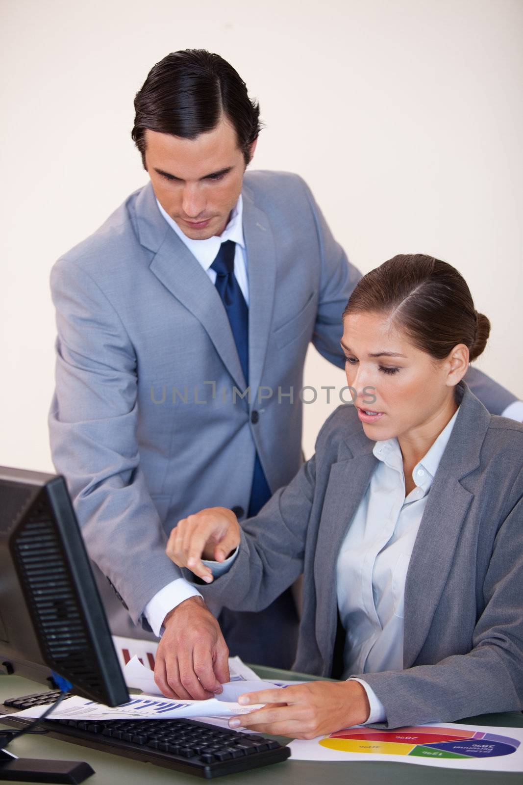 Young business people looking at statistics together