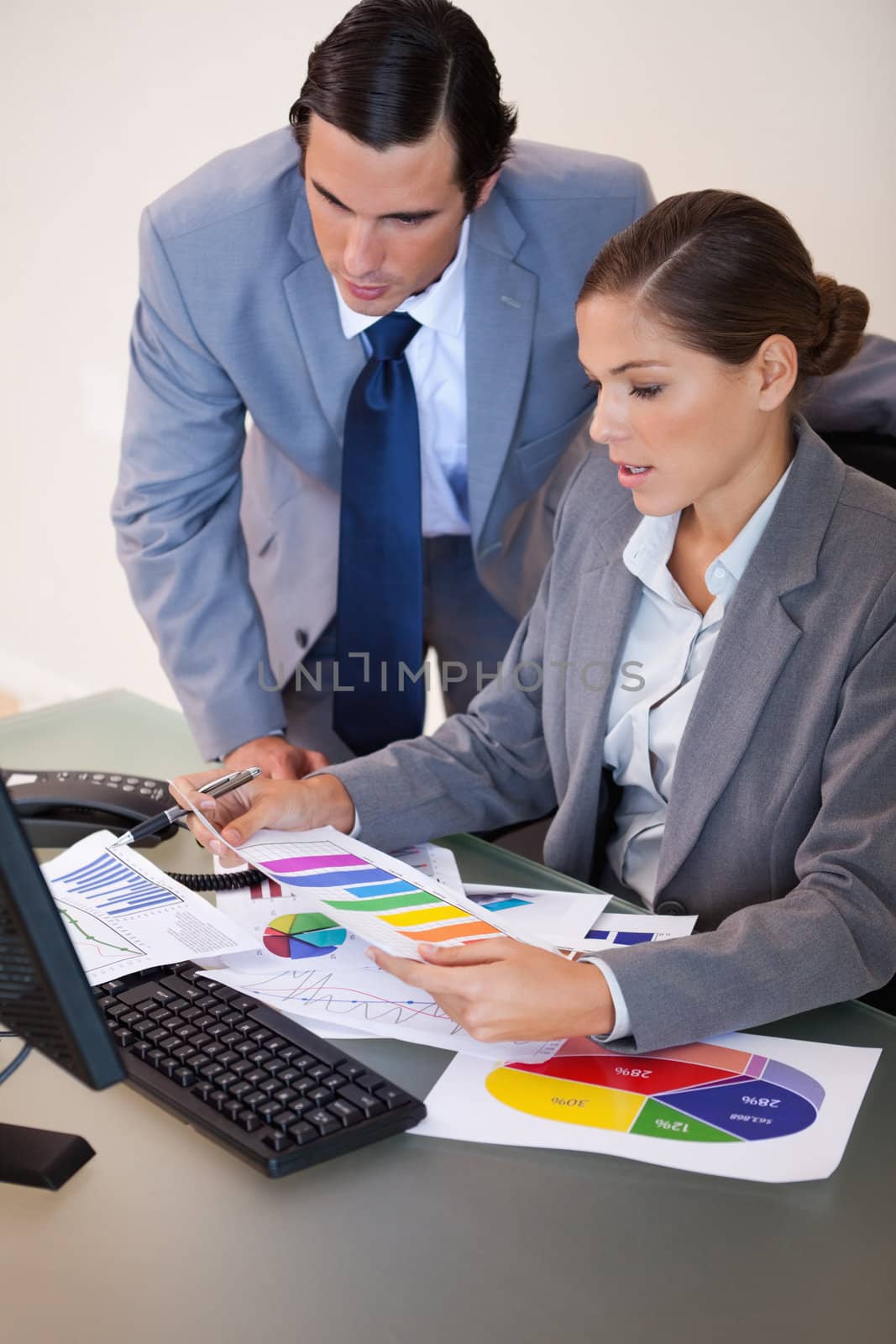 Young businesswoman explaining statistics to her colleague