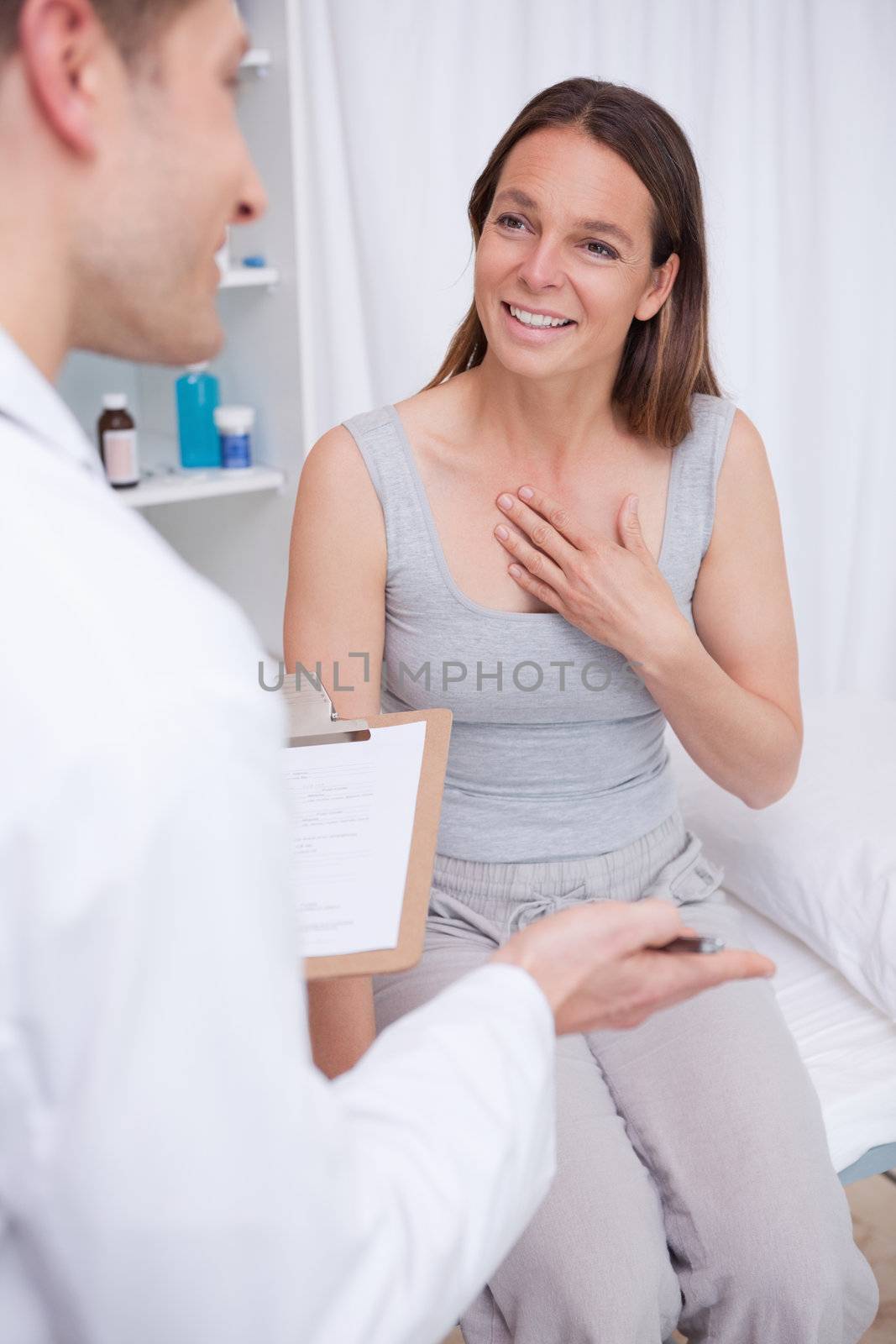 Patient talking to her doctor in examination room