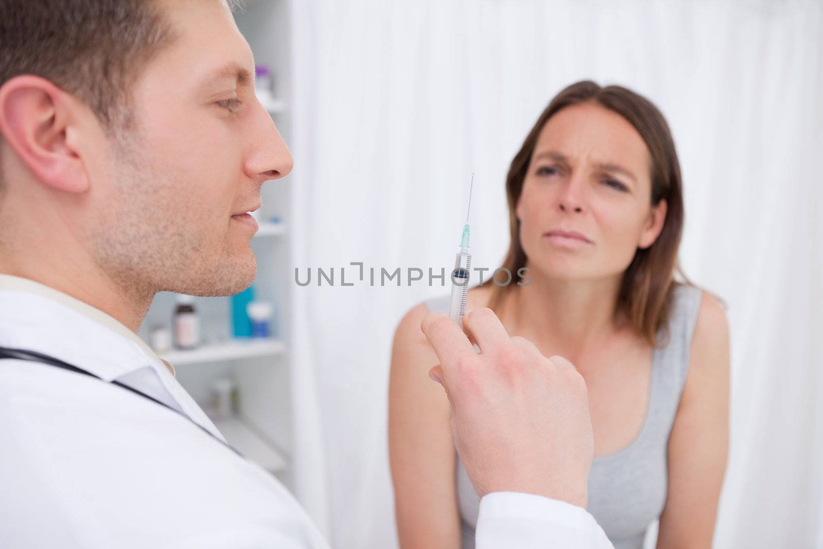 Doctor preparing injection for patient