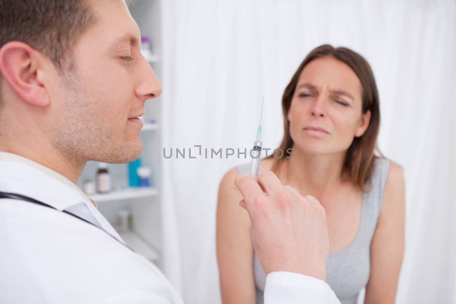 Doctor about to give an injection to patient