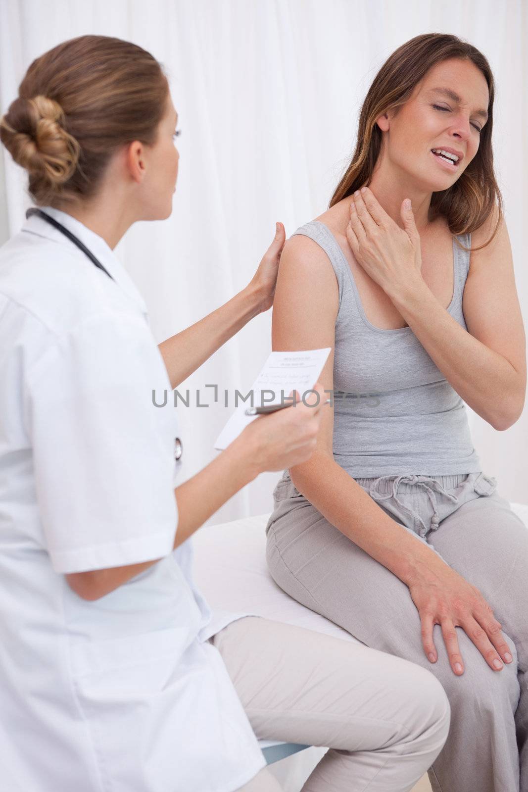 Patient showing painful spot to doctor