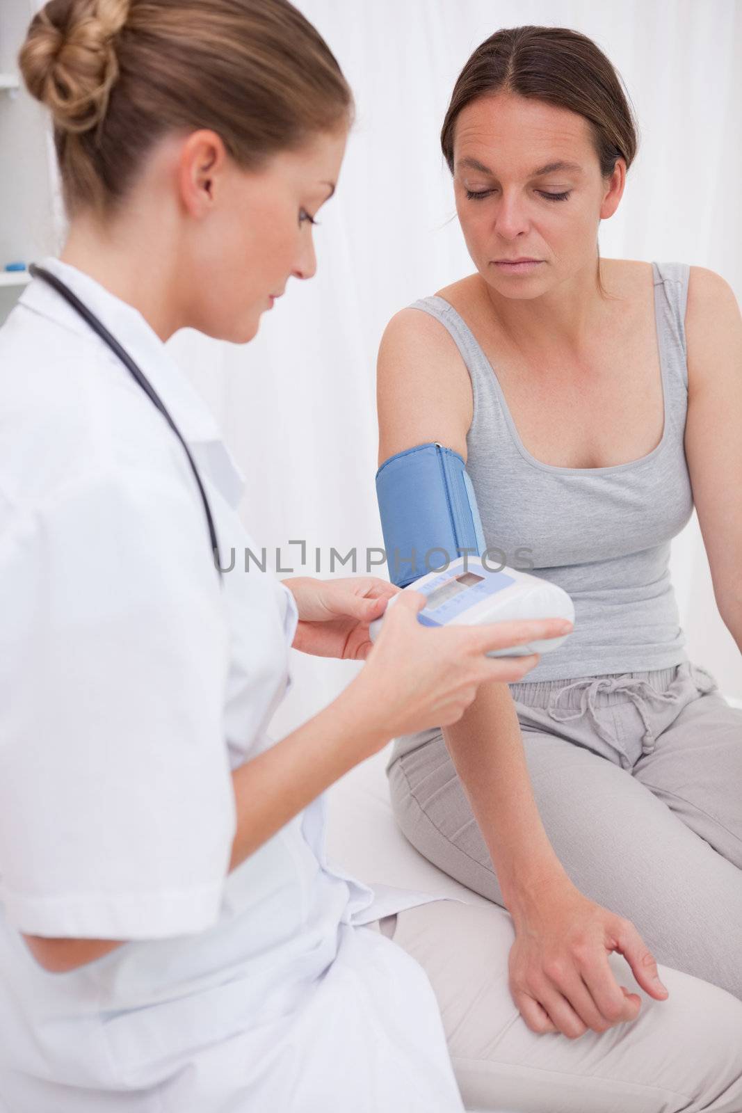 Doctor measuring patients blood pressure