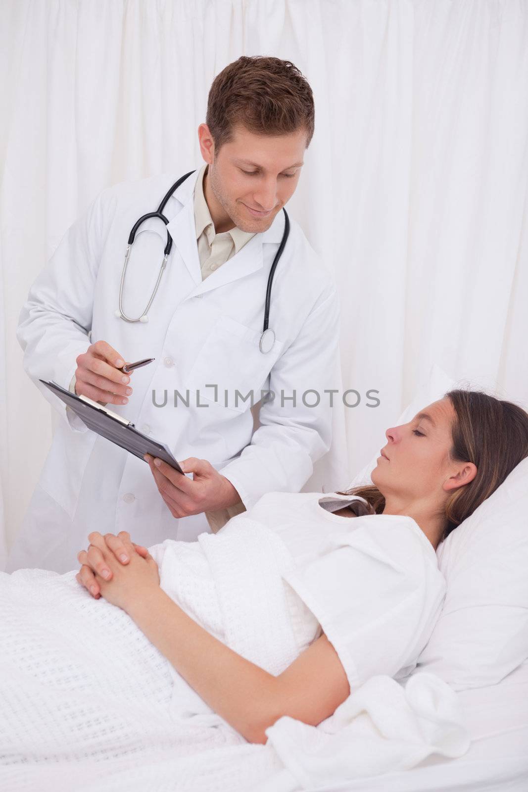 Doctor standing next to bedridden patient
