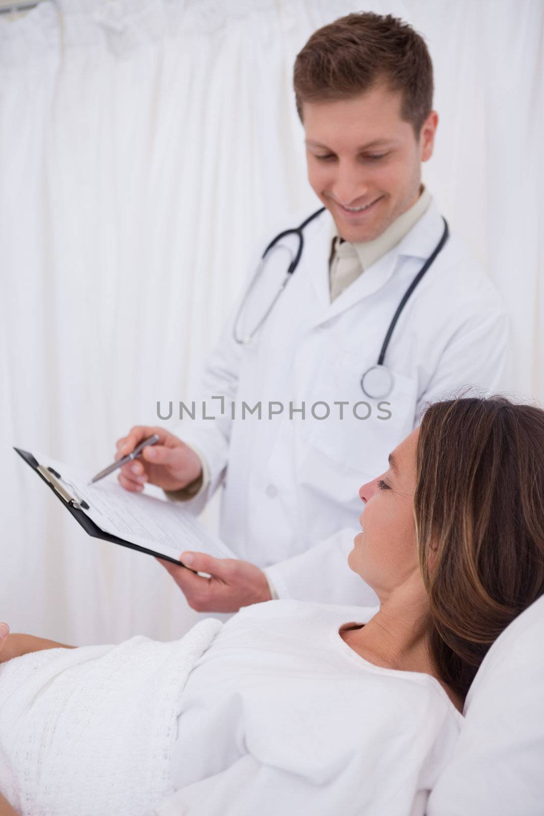 Smiling doctor talking about further steps with his patient