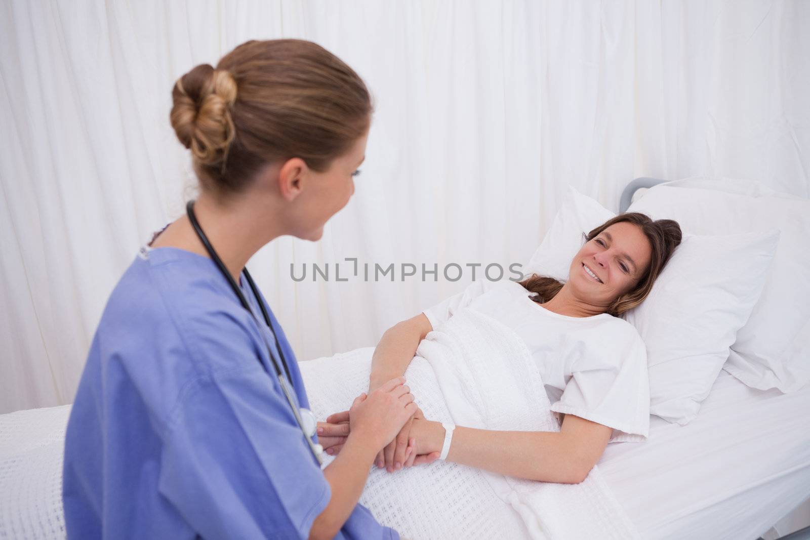 Surgeon visiting her bedridden patient