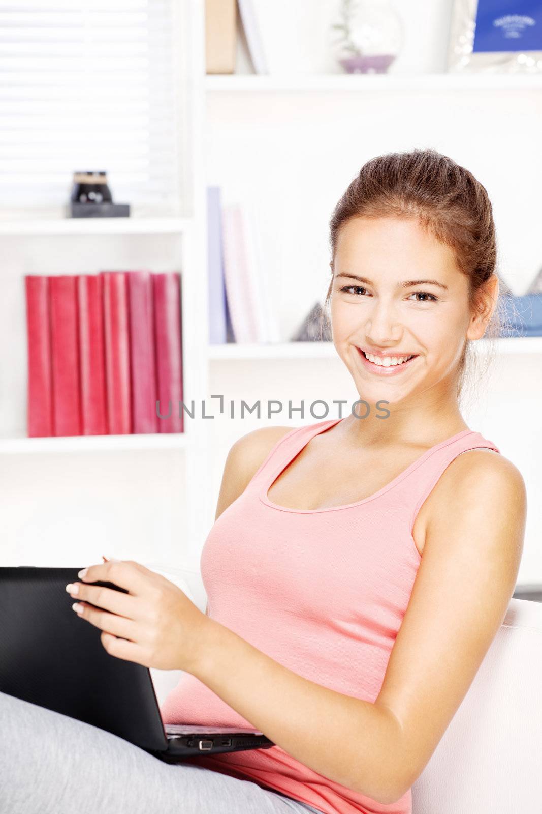 woman smiling while working on laptop by imarin