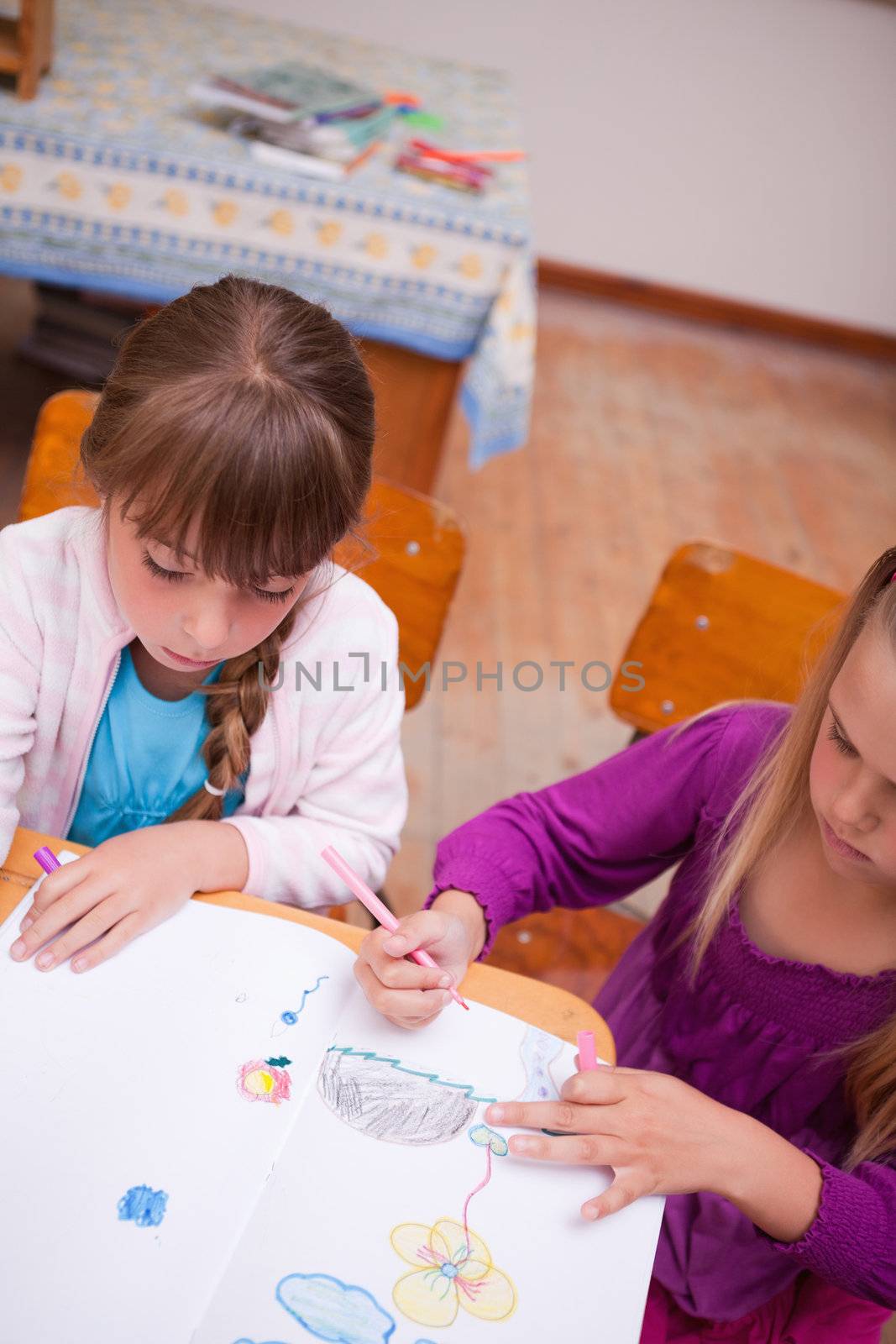 Portrait of a schoolgirls drawing in a classroom