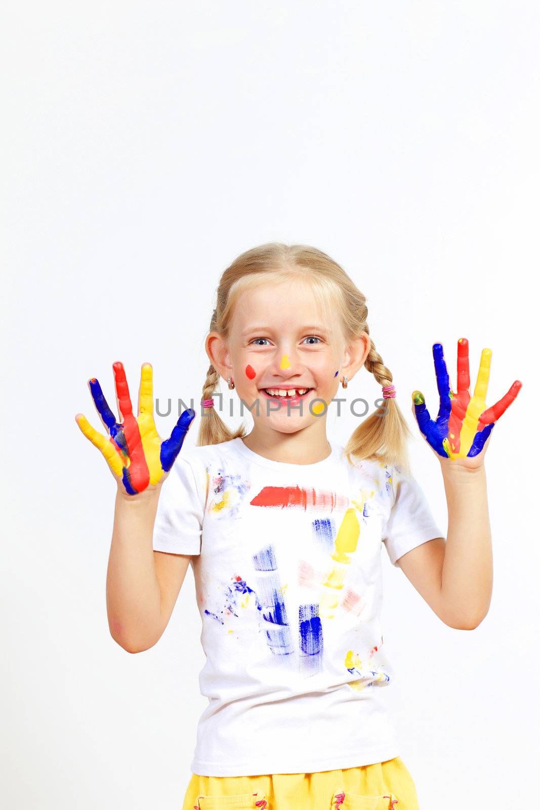 little child with hands painted in colorful paints ready for hand prints