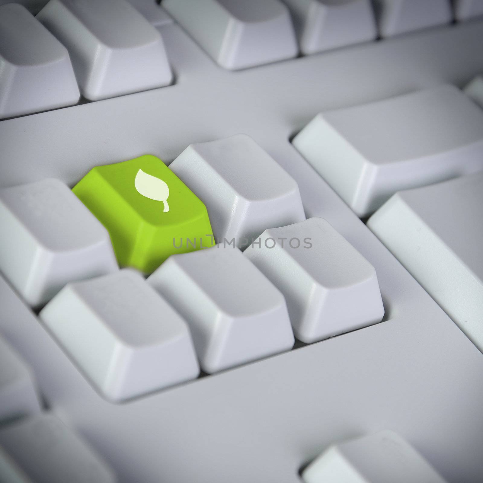 Computer keyboard with green Enter key with recycling symbol business concept