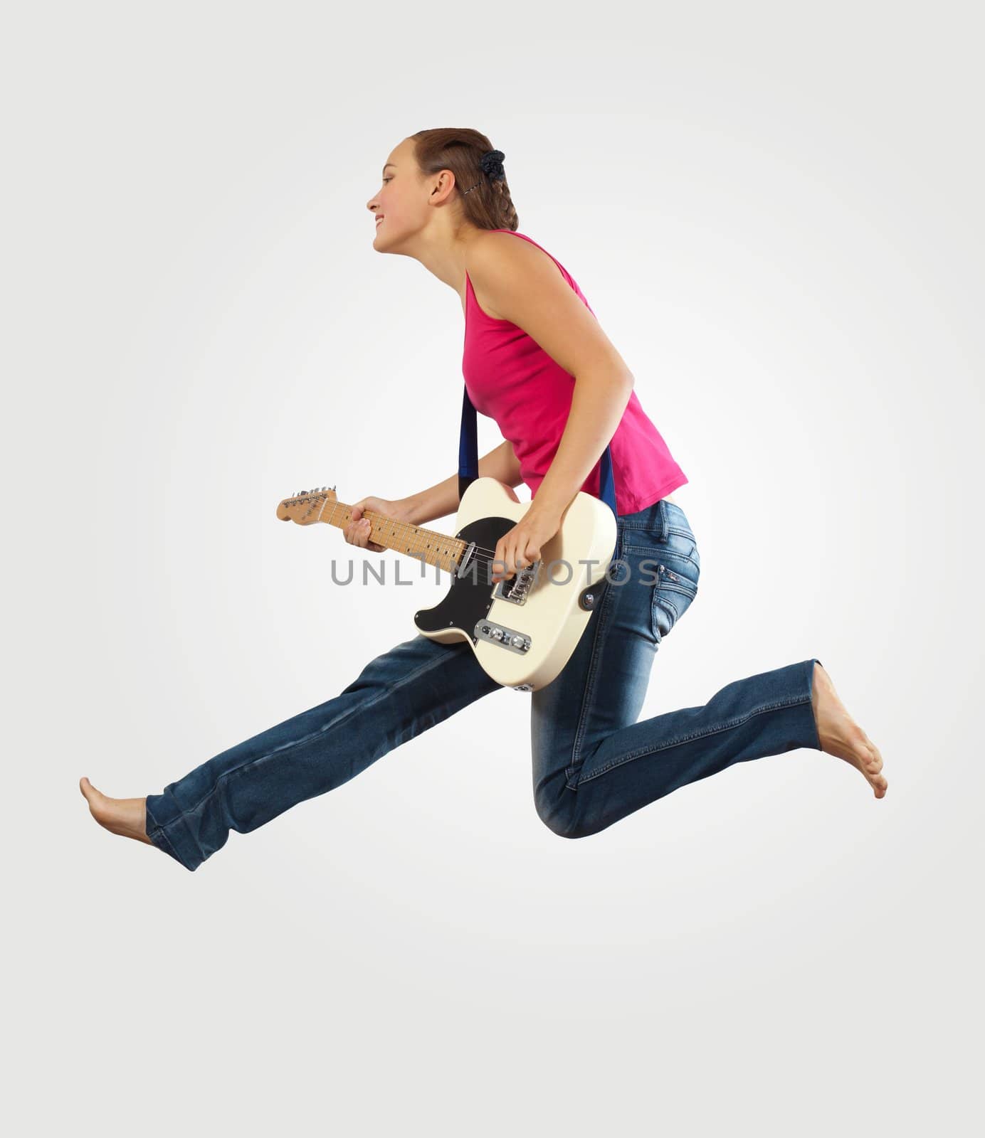 young woman playing on electro guitar and jumping