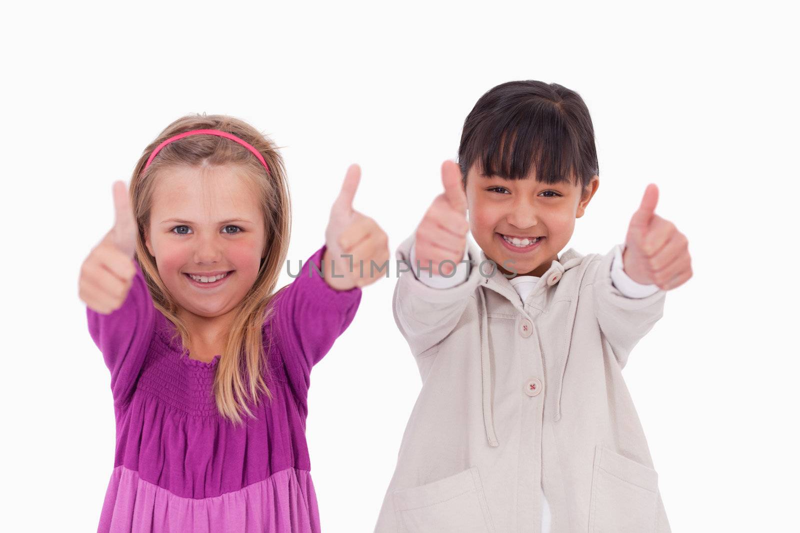 Girls with the thumbs up against a white background