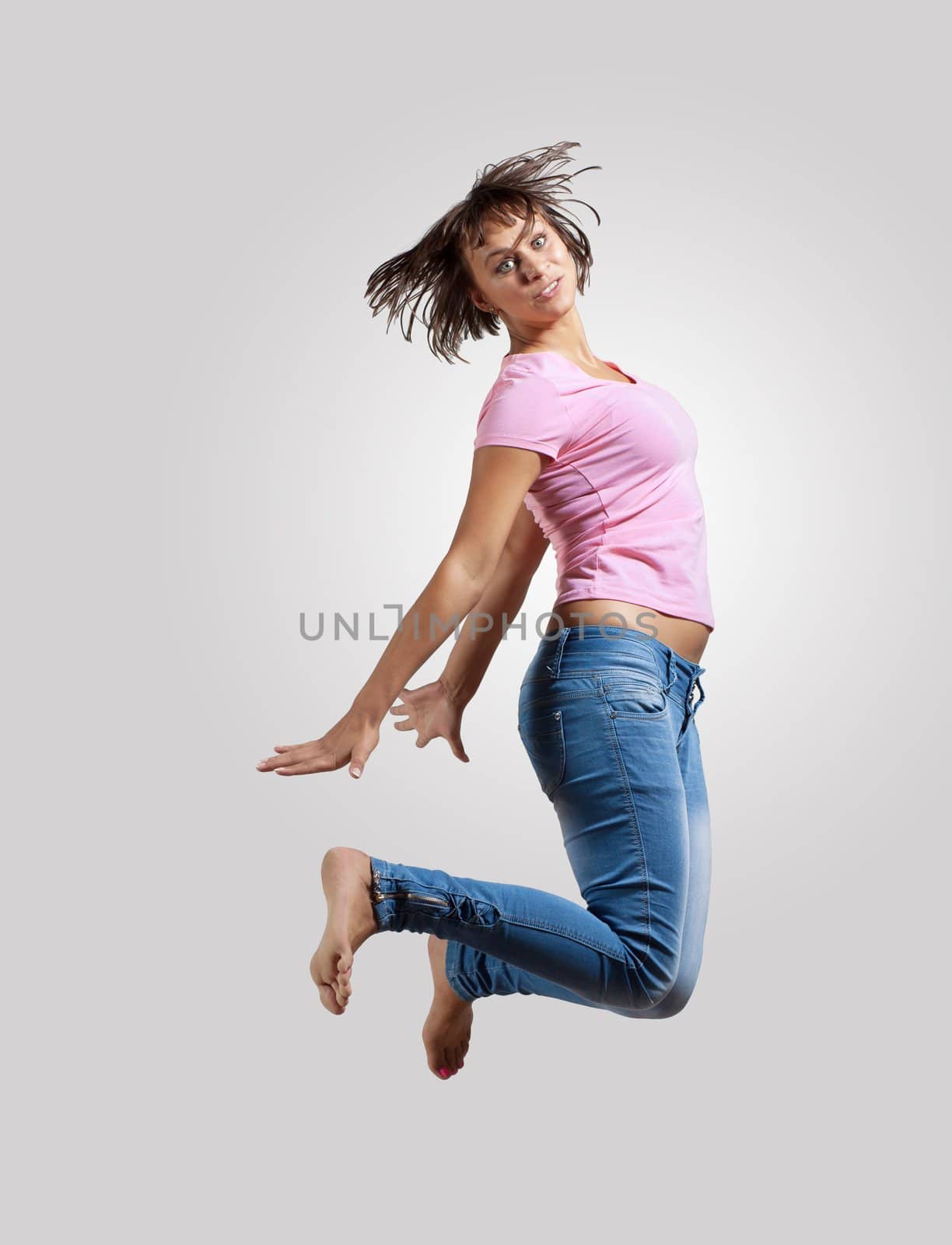 pretty modern slim hip-hop style woman jumping dancing on a colour background