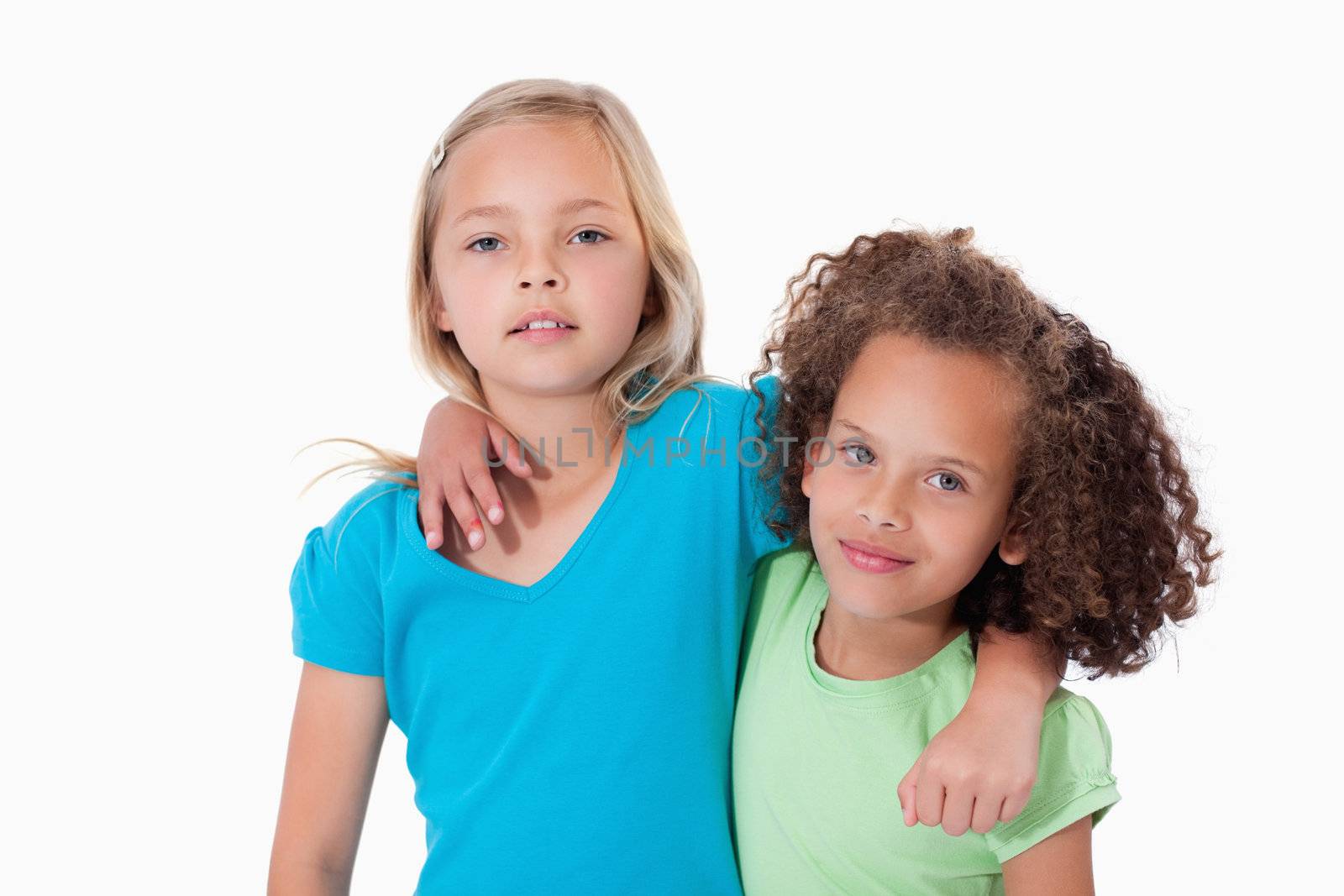 Young friends posing against a white background