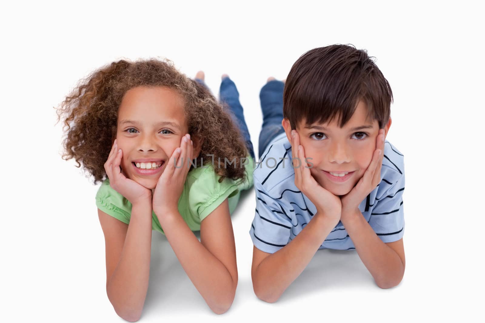 Lovely friends lying on the floor against a white background