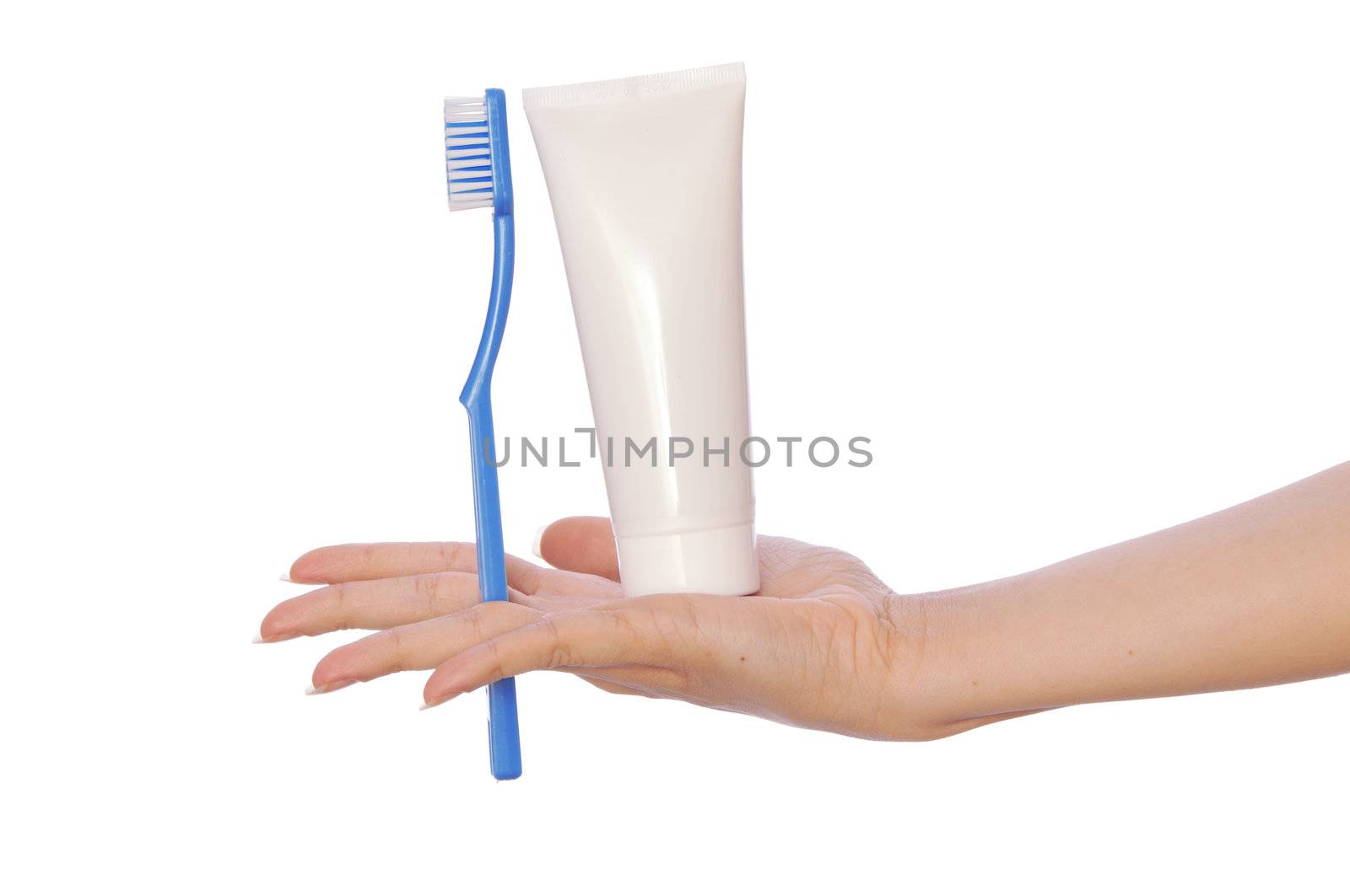 Tooth-paste and brush at in the girl's hand