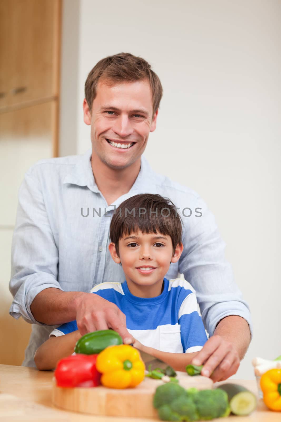 Father and son preparing vegetables together