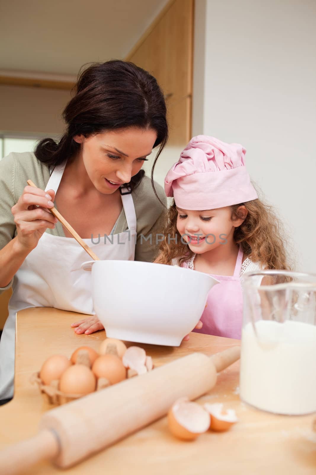 Mother and daughter preparing cookies together