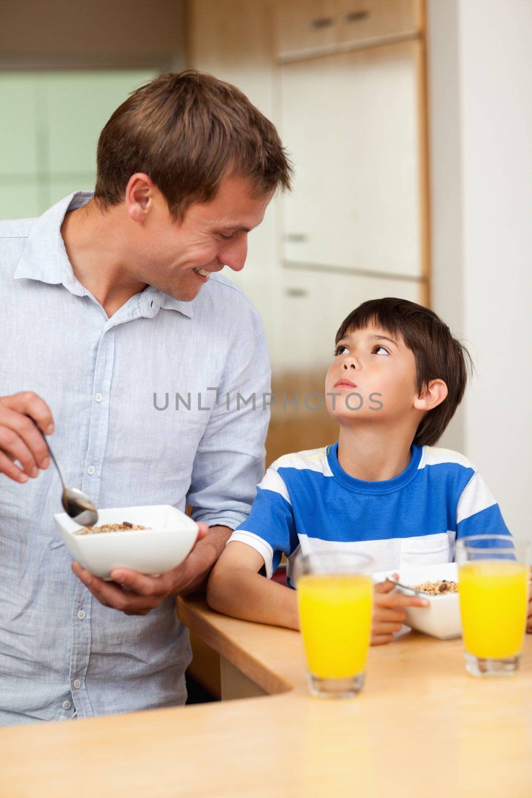 Father and son having healthy breakfast together