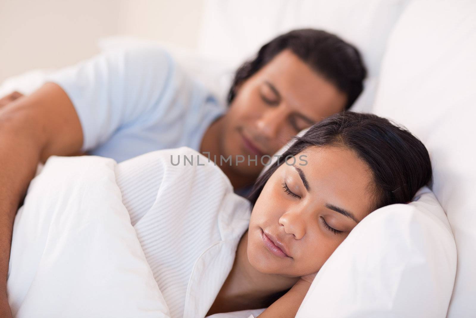 Side view of young couple being asleep