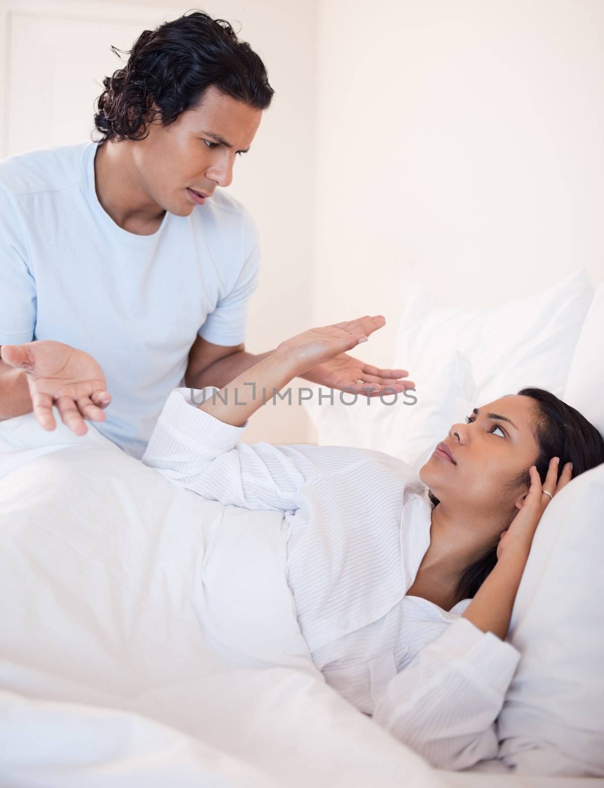 Young couple arguing in the bedroom