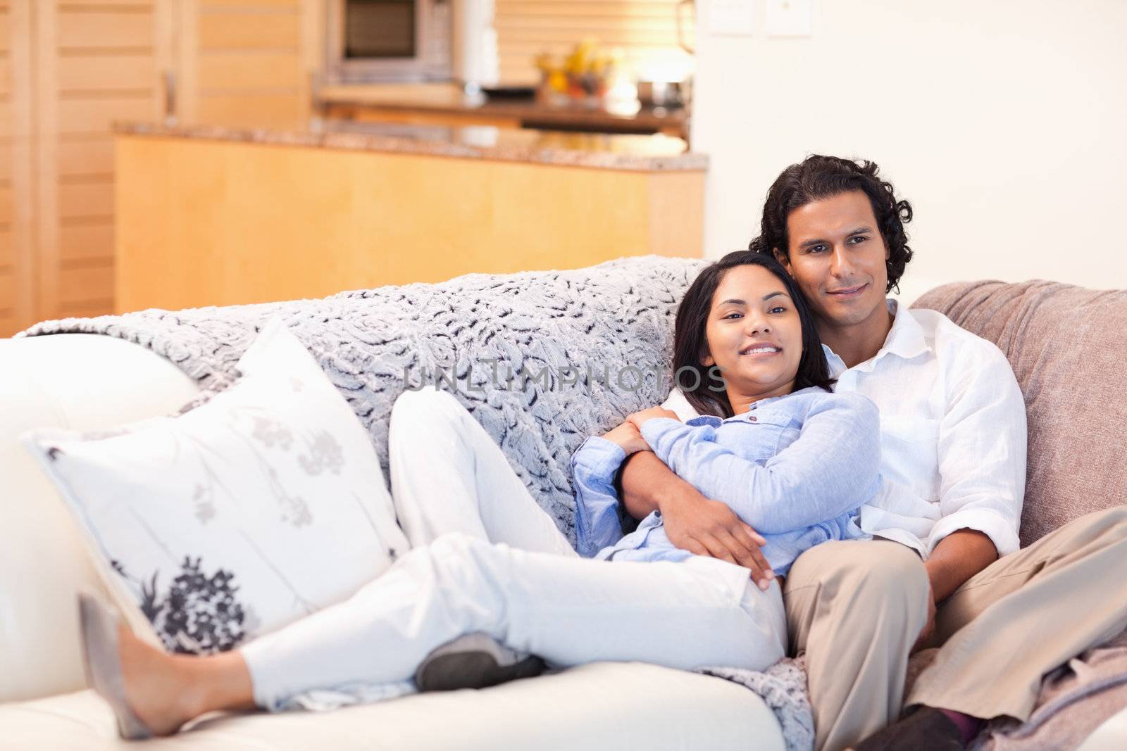 Happy young couple on the couch together