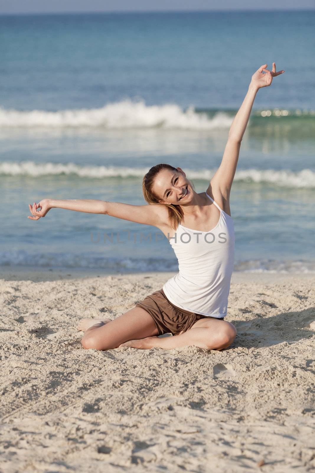 Young woman with black bikini girl on the beach in the sea jumping in the summer holidays