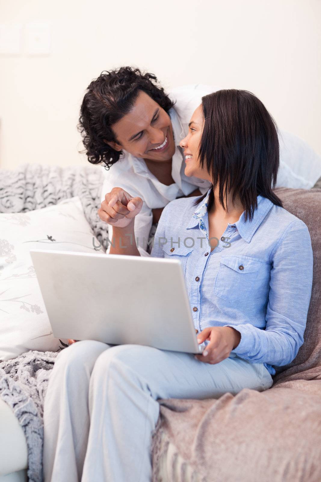 Young couple surfing the internet on the sofa