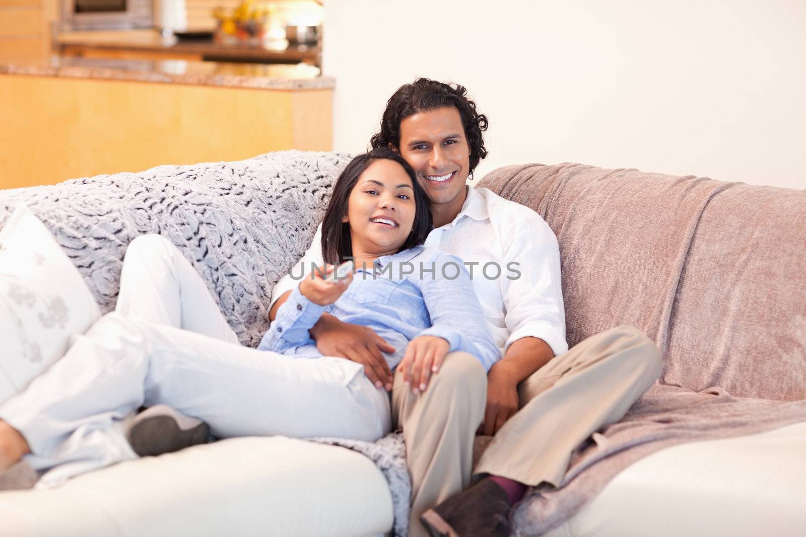 Young couple enjoys watching television together