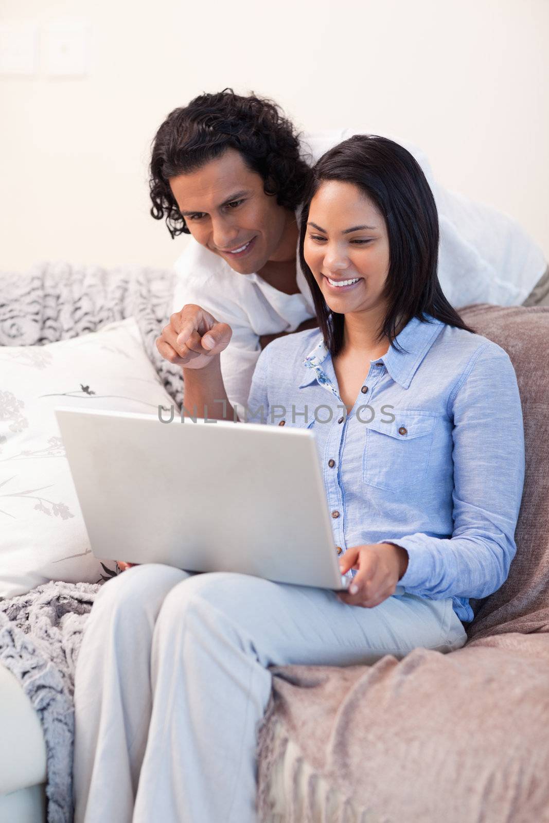 Young couple on the sofa surfing the internet together