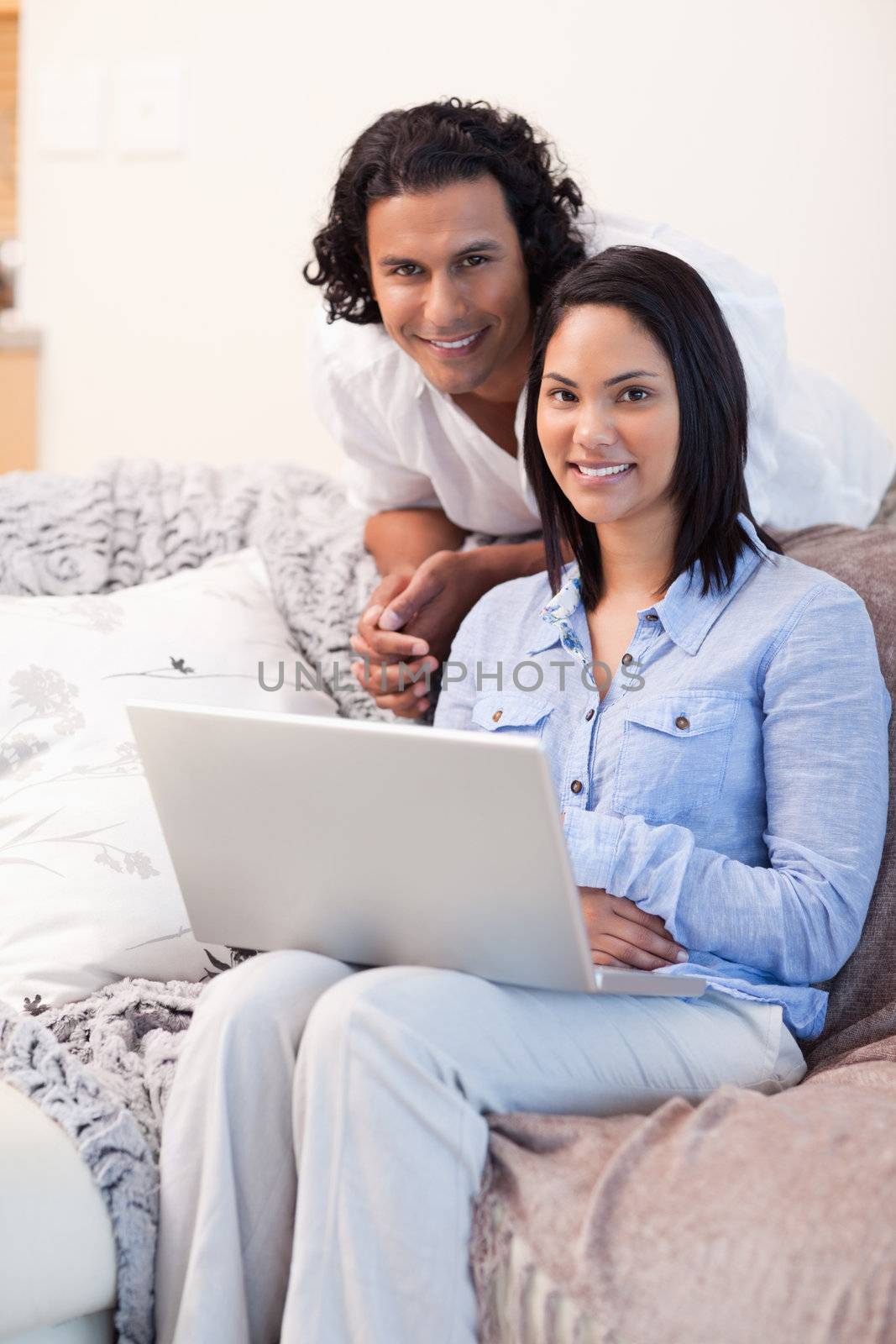 Young couple surfing the internet on the couch
